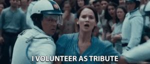 A GIF of the scene in The Hunger Games movie where Katniss Everdeen volunteers as tribute in place of her sister (image courtesy Tenor.com)